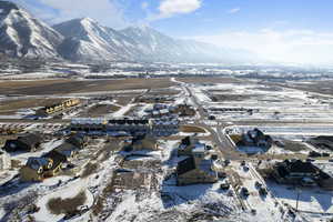 Snowy aerial view with a mountain view and a residential view