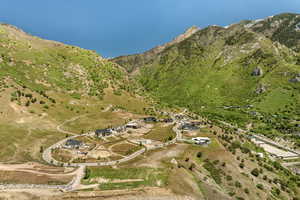 Aerial view of property and surrounding area featuring a mountain backdrop