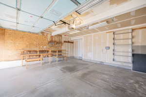 Garage featuring a workshop area and a garage door opener