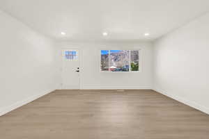 Foyer featuring recessed lighting, baseboards, and light wood-style floors