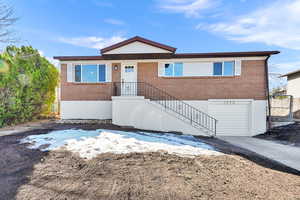 Ranch-style house featuring brick siding, concrete driveway, and a garage