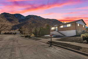 Exterior space with a mountain view, curbs, and sidewalks