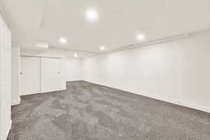 Finished below grade area featuring recessed lighting, baseboards, and carpet flooring