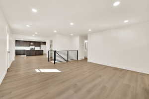 Spare room featuring recessed lighting, baseboards, and light wood finished floors