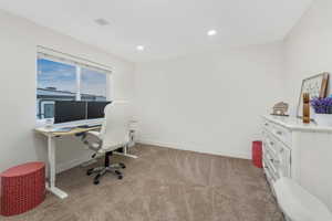 Home office with recessed lighting, baseboards, and light carpet