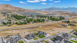 Aerial overview of property's location featuring a mountain backdrop and nearby suburban area
