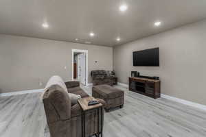 ADU Living area featuring visible vents, recessed lighting, baseboards, and light wood-style floors