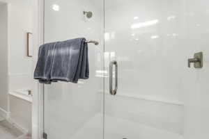 Full bathroom with a shower stall and a garden tub