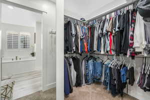 Walk in closet featuring carpet flooring