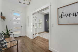 Entryway with baseboards and wood finished floors