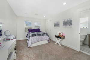 Ensuite Bedroom featuring carpet flooring, recessed lighting, ensuite bathroom, and baseboards