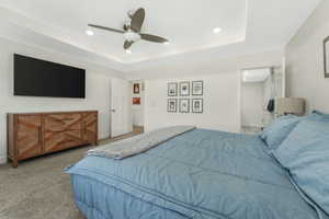 Bedroom featuring recessed lighting, a tray ceiling, ceiling fan, and carpet flooring