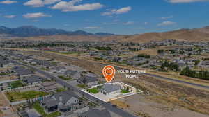 Aerial perspective of suburban area featuring a mountain backdrop
