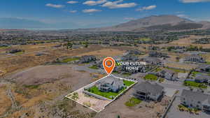 Aerial view of residential area with property parcel outlined and a mountainous background