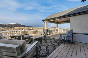 Wooden deck featuring a mountain view and an outdoor hangout area