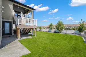 Fenced backyard with a patio, stairway, and a mountain view