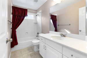 Full bath featuring vanity, shower / bath combination