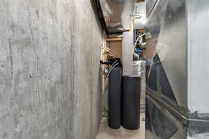 View of utilities room with a water softener