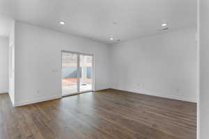 Spare room with recessed lighting, visible vents, baseboards, and dark wood-type flooring