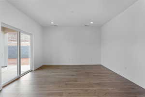 Empty room featuring recessed lighting, baseboards, and wood finished floors