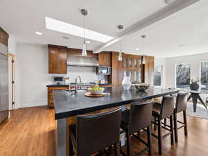 Gourmet Kitchen with solid walnut cabinetry, Professional appliances & black honed granite countertops