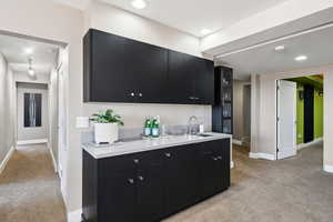 Wet bar between family room and theater room - entertainment central