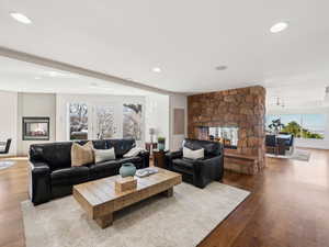 Beautiful Sandstone gas fireplace connects the family room & formal dining room