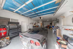 Garage featuring a workshop area and a garage door opener