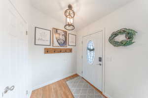 Entryway featuring baseboards and light wood-type flooring