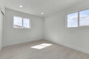 Unfurnished room with recessed lighting, visible vents, baseboards, and light wood finished floors