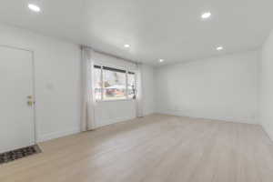 Empty room with visible vents, recessed lighting, baseboards, and light wood-style floors