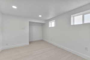 Basement with recessed lighting, baseboards, and light wood-style floors