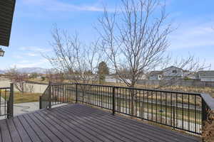 Wooden terrace with a residential view, a mountain view, and a fenced backyard