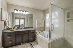 Bathroom with visible vents, ensuite bath, a shower stall, a bath, and vanity