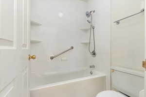 Full bathroom with toilet and washtub / shower combination