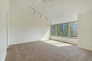 Carpeted empty room featuring visible vents, baseboards, and ceiling fan