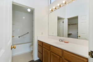 Bathroom featuring toilet, vanity, and tile patterned flooring