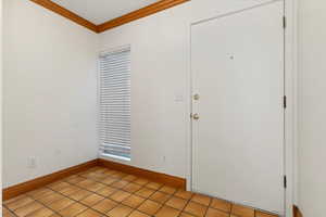 Foyer featuring baseboards and ornamental molding