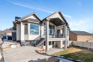 Rear view of property featuring a patio area, stucco siding, a lawn, and fence