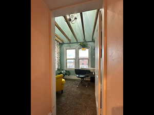 Office featuring vaulted ceiling, baseboards, carpet floors, and a chandelier