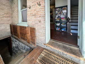 Entrance to property with brick siding