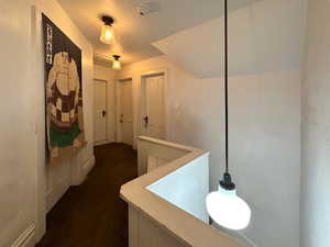 Corridor with dark colored carpet