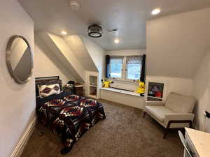 Bedroom featuring visible vents, baseboards, lofted ceiling, carpet floors, and recessed lighting