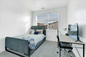 Bedroom with baseboards, visible vents, and carpet floors