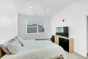 Carpeted bedroom with recessed lighting, visible vents, lofted ceiling, and baseboards