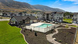 Community pool featuring a mountain view, a residential view, a patio, and fence