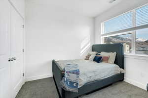 Carpeted bedroom with visible vents and baseboards