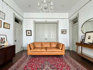 Living room with a notable chandelier and wood finished floors