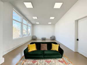 Sitting room featuring finished concrete flooring