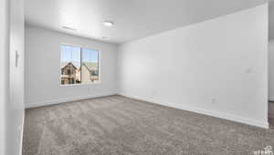 Spare room with visible vents, baseboards, carpet, and a textured ceiling